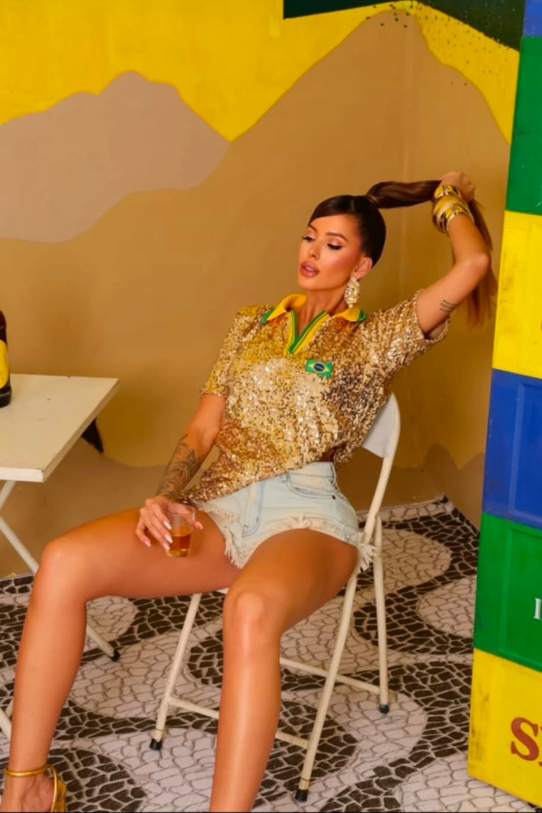 Gold sequin short-sleeve polo shirt with yellow-green collar and Brazilian flag patch, fitted party style for Brazilian women and festival fashion